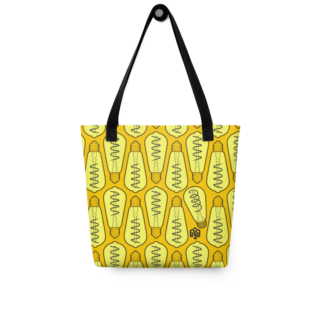Bolsa tote colgada, vista frontal, con patrón isométrico de bombillas encendidas en alto contraste y un foco distinto integrado en el diseño.