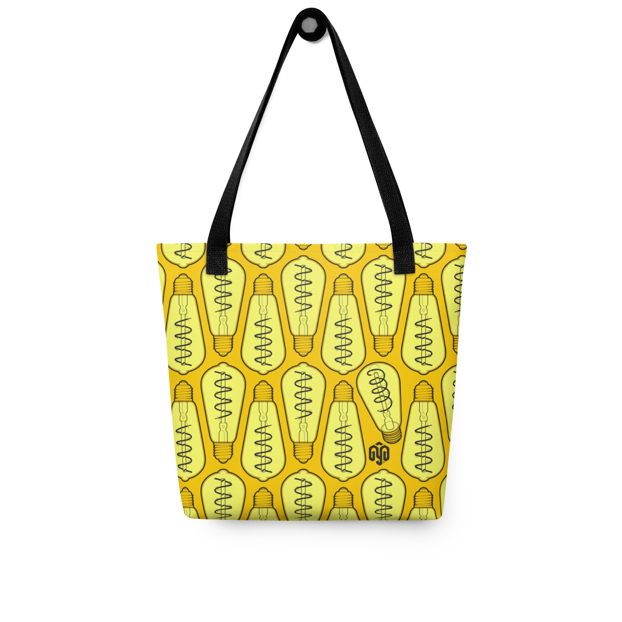 Bolsa tote colgada, vista frontal, con patrón isométrico de bombillas encendidas en alto contraste y un foco distinto integrado en el diseño.
