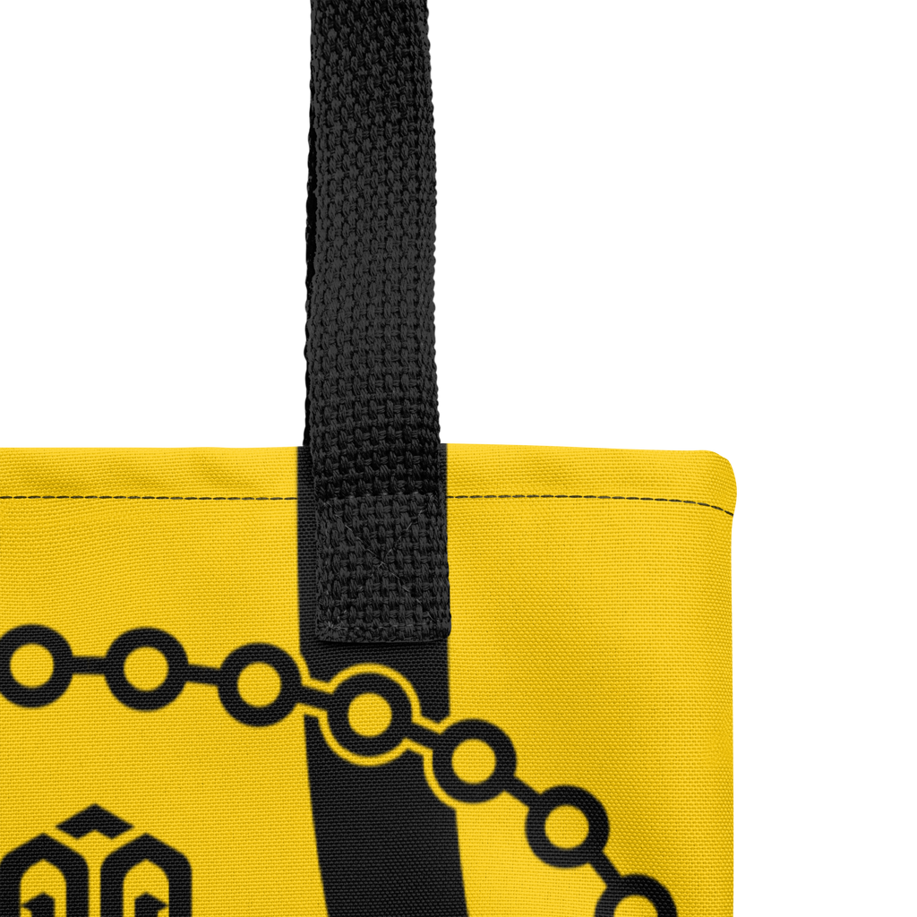 Detalle de las asas de la bolsa tote mostrando costuras reforzadas y acabados de la cinta de algodón.