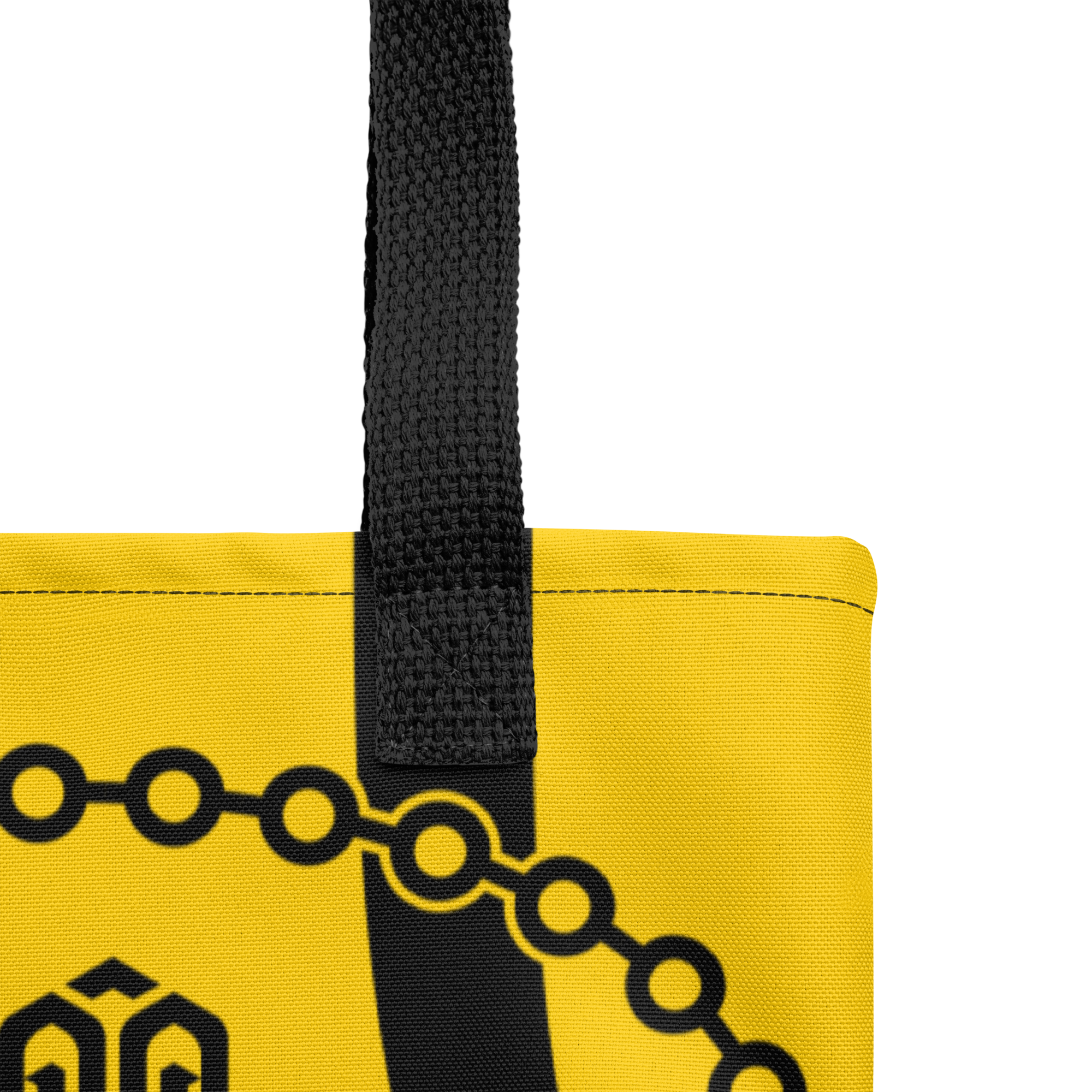 Detalle de las asas de la bolsa tote mostrando costuras reforzadas y acabados de la cinta de algodón.