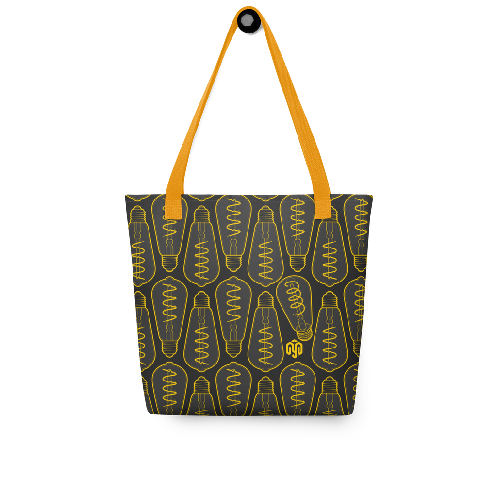 Bolsa tote colgada, vista frontal, con patrón isométrico de bombillas apagadas en tonos oscuros y un foco distinto integrado en el diseño.