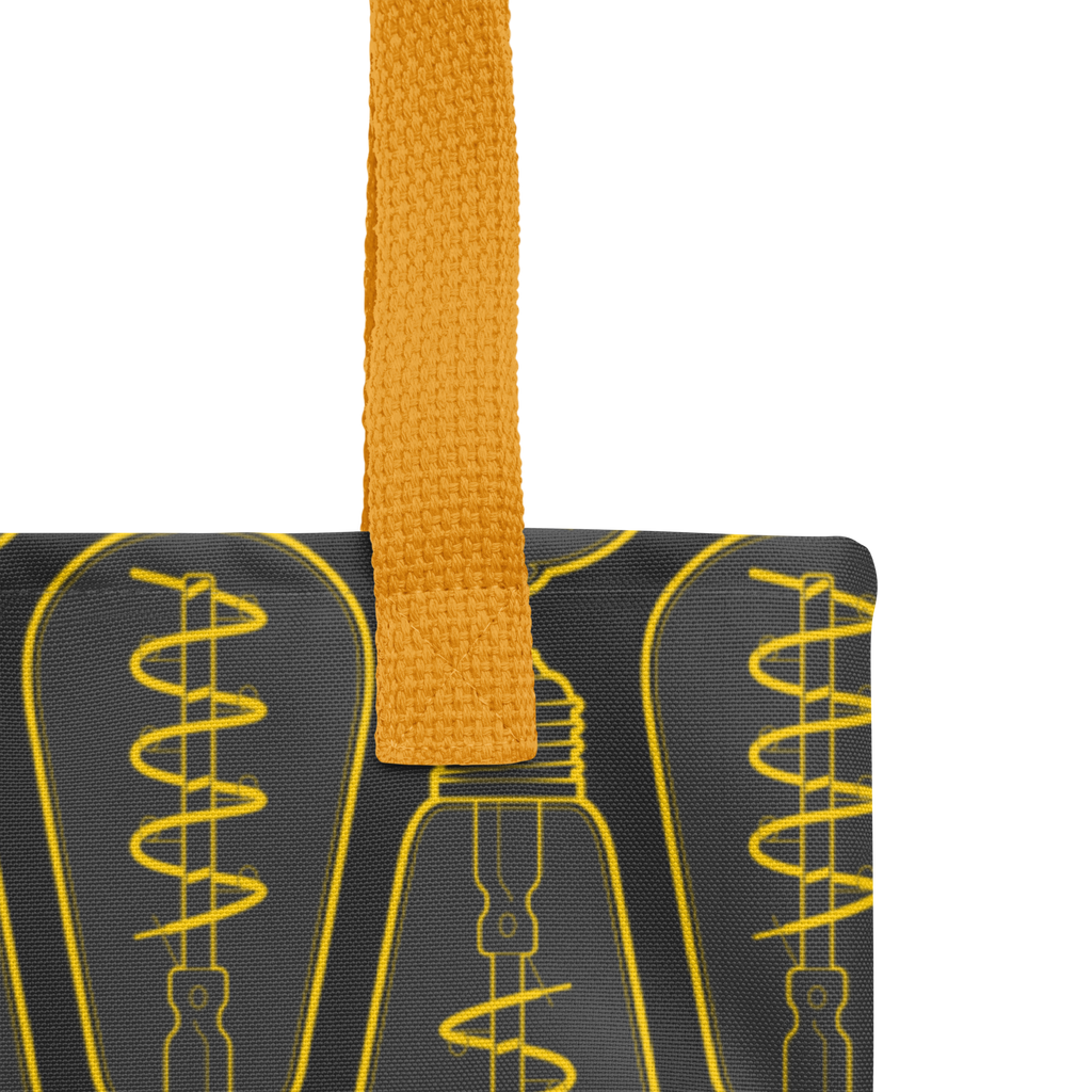 Primer plano de las asas de la bolsa tote con detalle de costuras, remates y textura de la cinta.